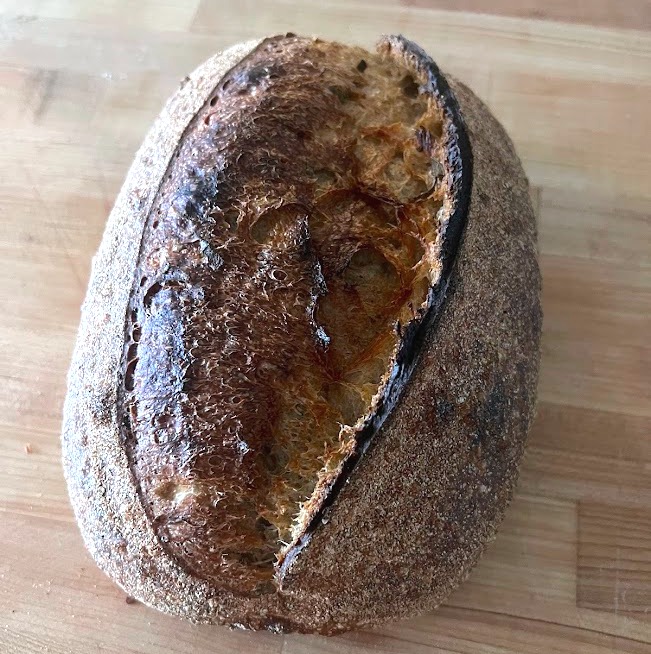 Baked herb-loaded sourdough loaf